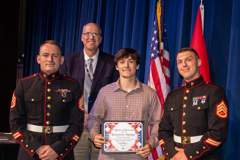 A student is honored for serving in the US Armed Forces after high school